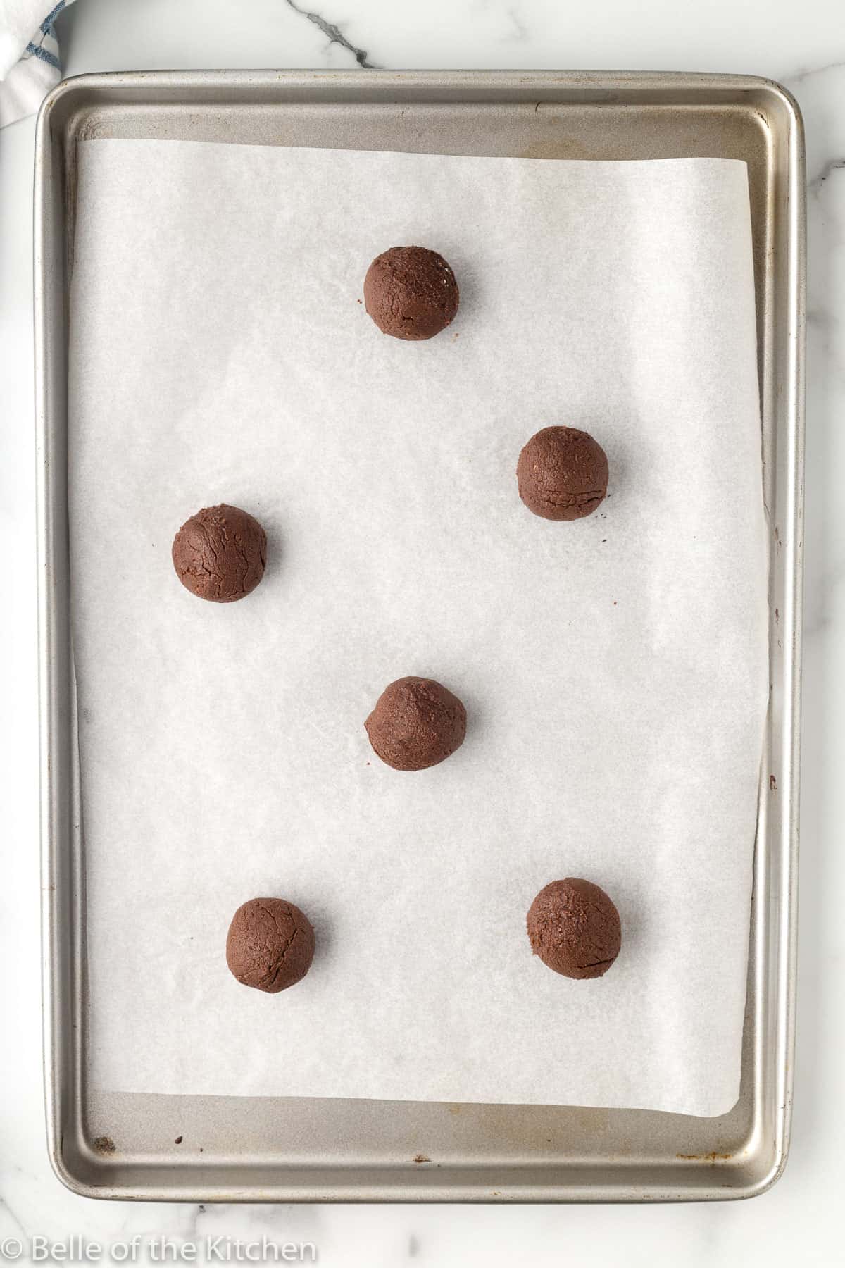 cookie dough balls on a sheet pan