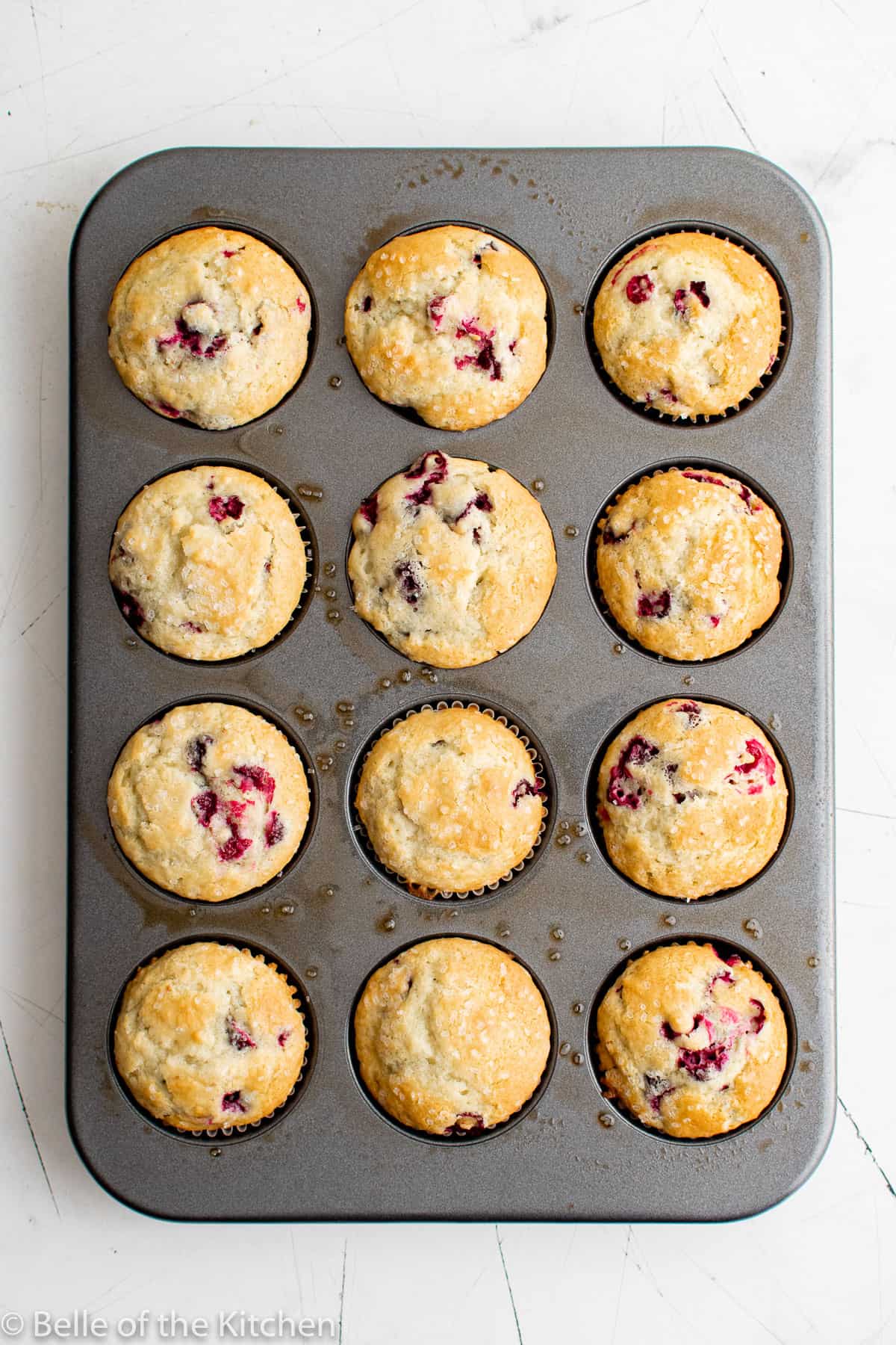 cranberry muffins in a baking tin