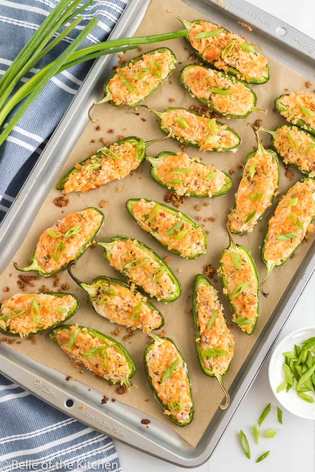 cream cheese stuffed peppers on a sheet pan