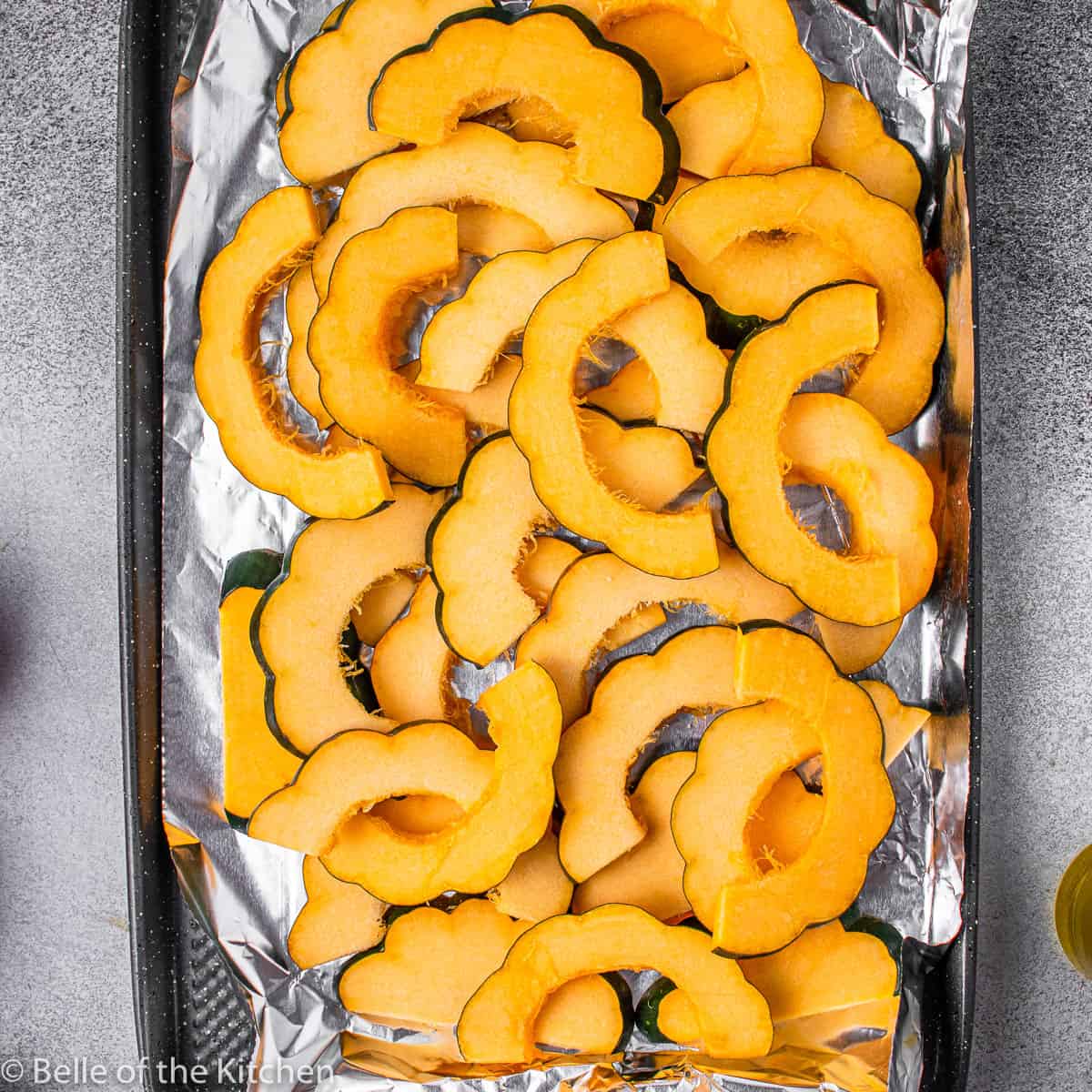 sliced acorn squash on a cookie sheet
