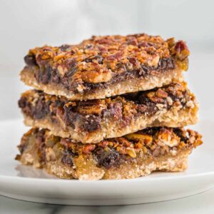 a stack of three chocolate pecan pie bars