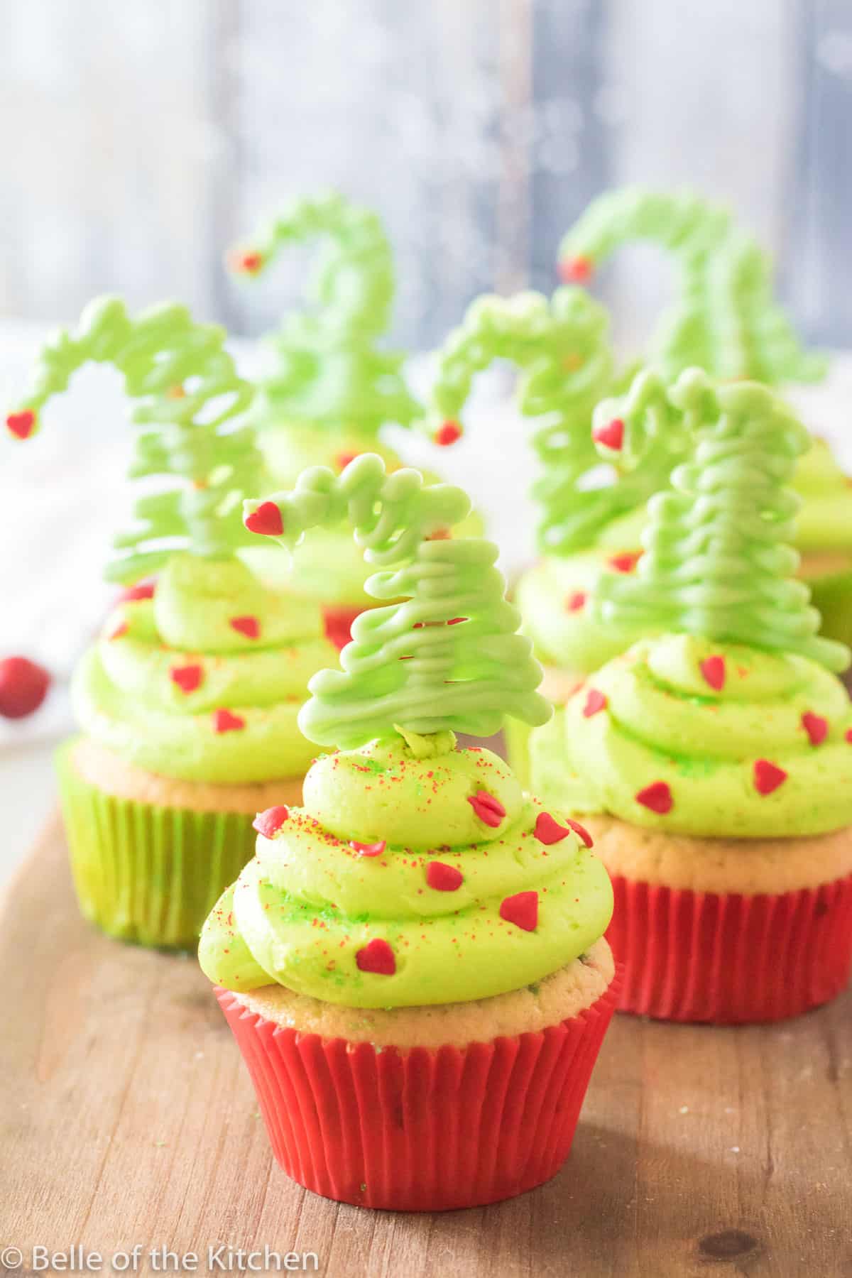 cupcakes with green frosting and pretzel trees on top