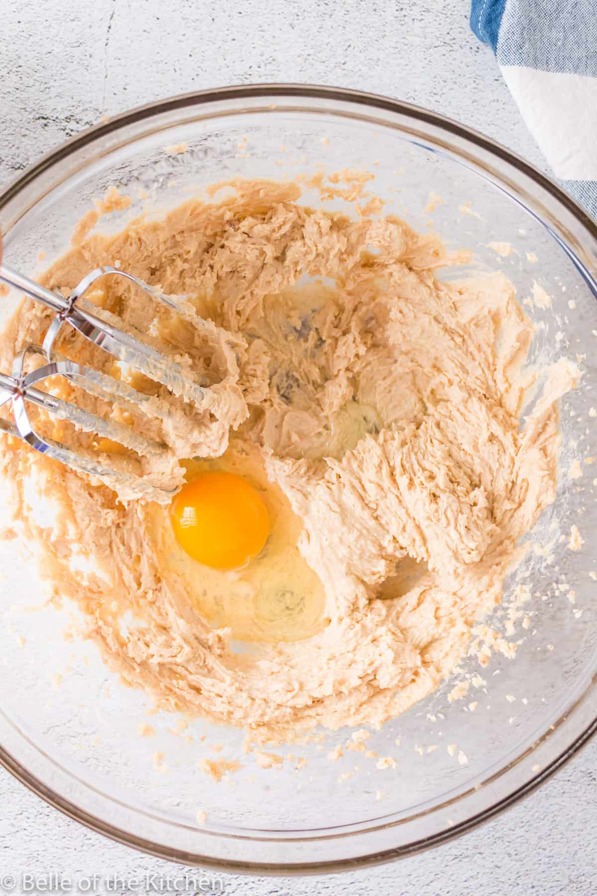 an egg in a bowl of batter