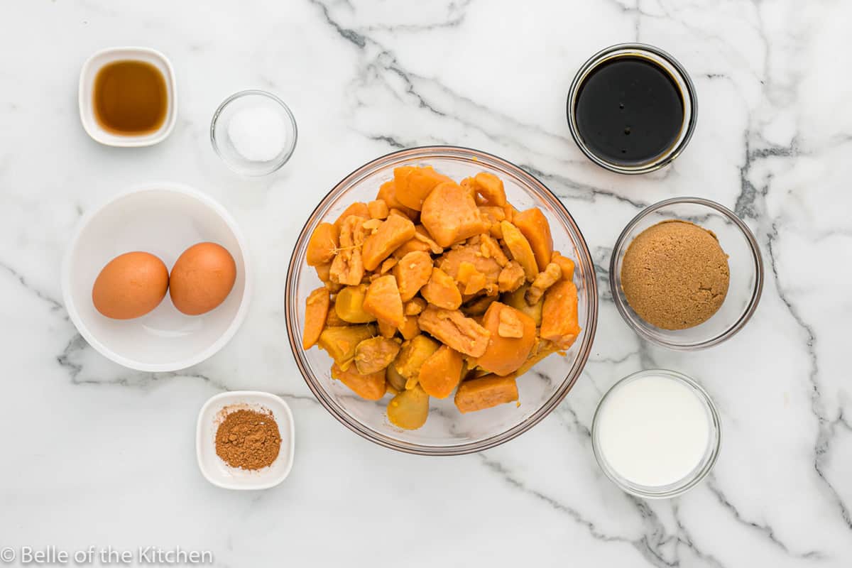sweet potatoes, sugar, eggs, and spices on a marble background