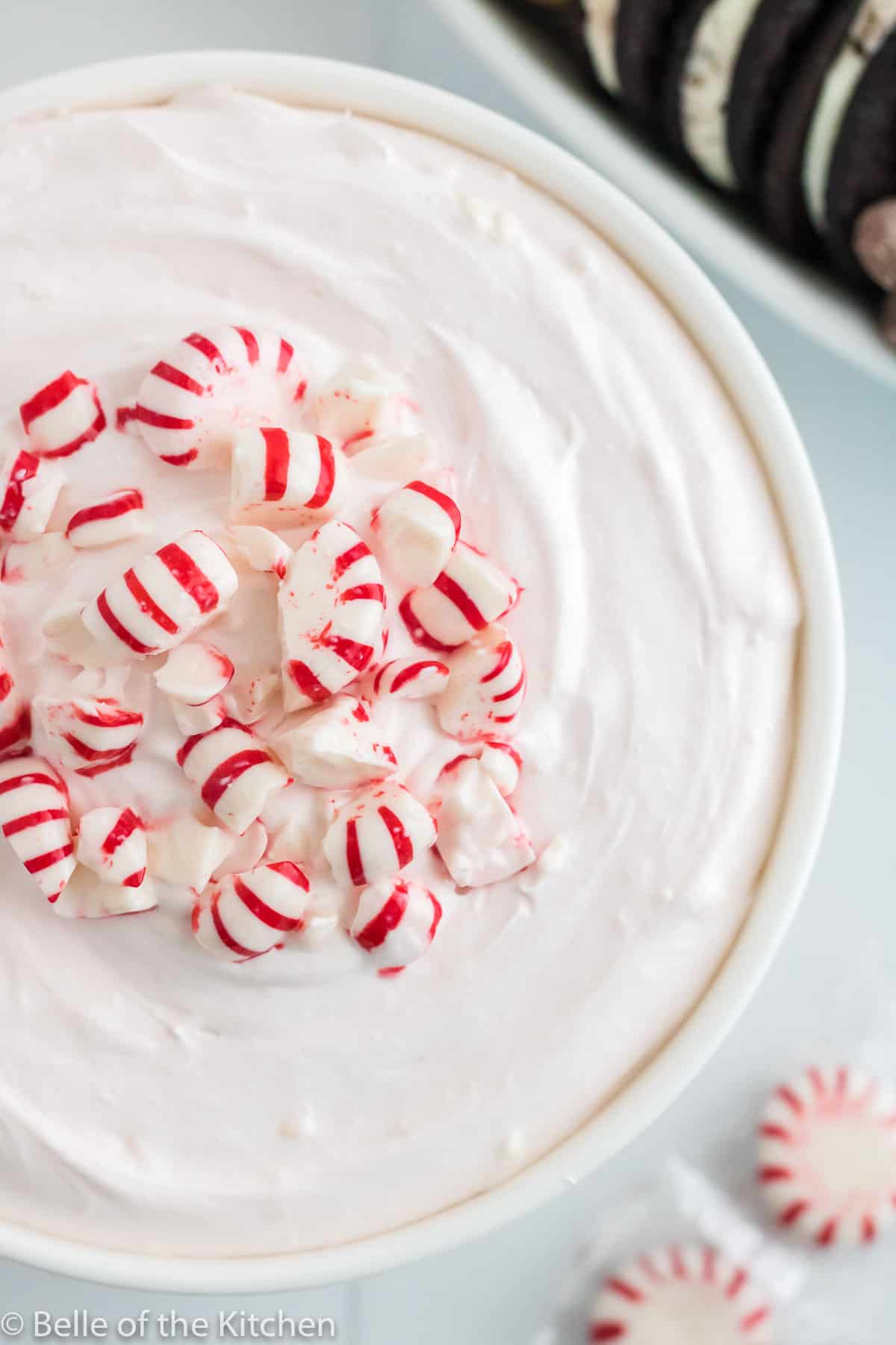 a bowl of cheesecake dip with peppermints on top