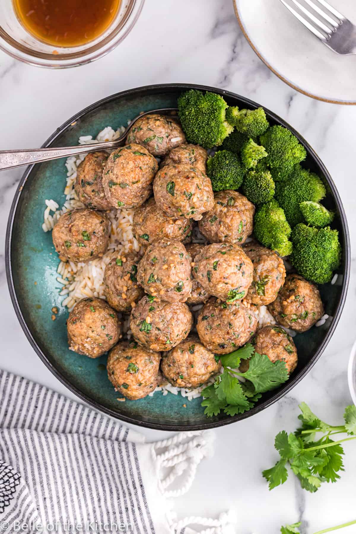 a bowl of Asian Turkey meatballs and broccoli