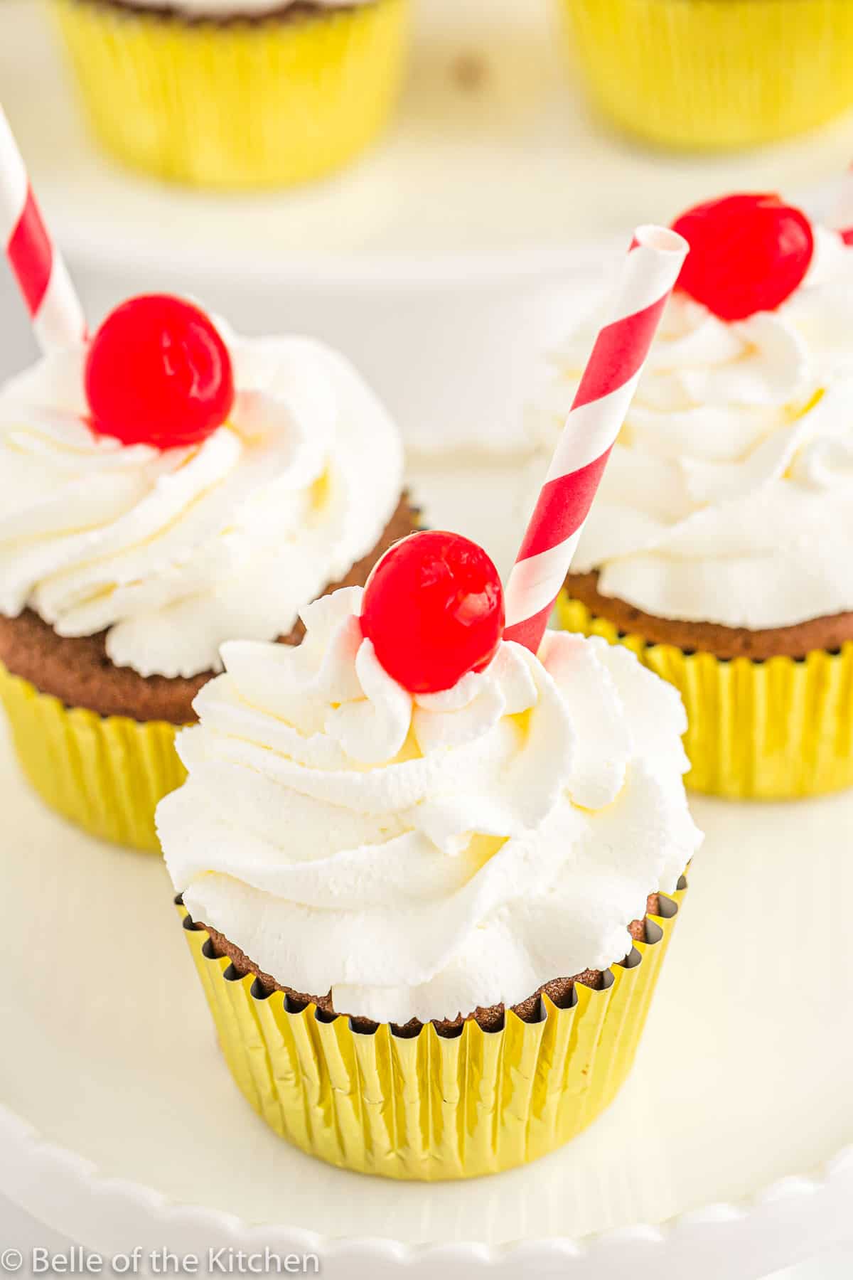 a cupcake with a cherry and straw on top