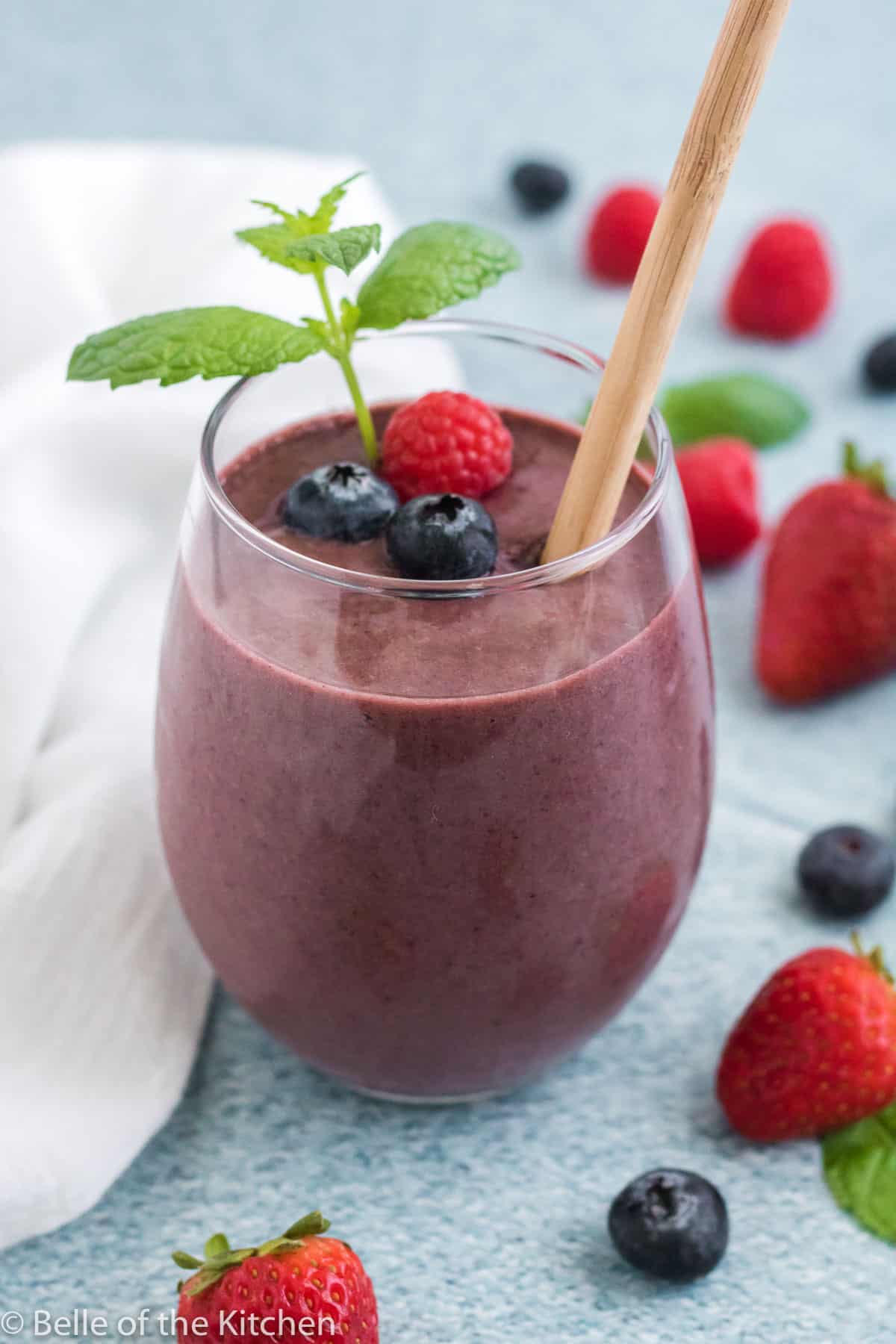 greek yogurt smoothie topped with berries and mint