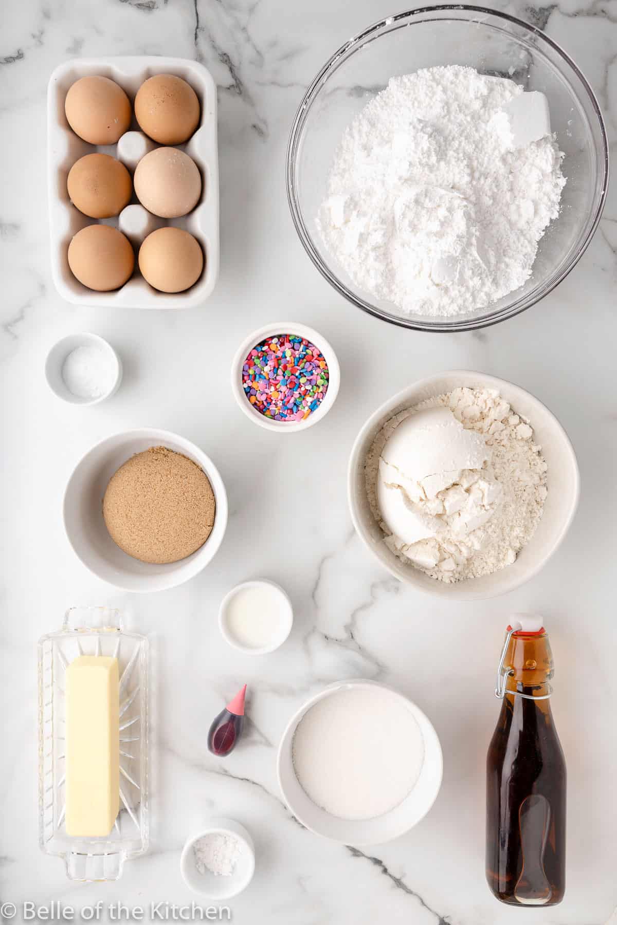 ingredients laid out on a marble background to make sugar cookie bars