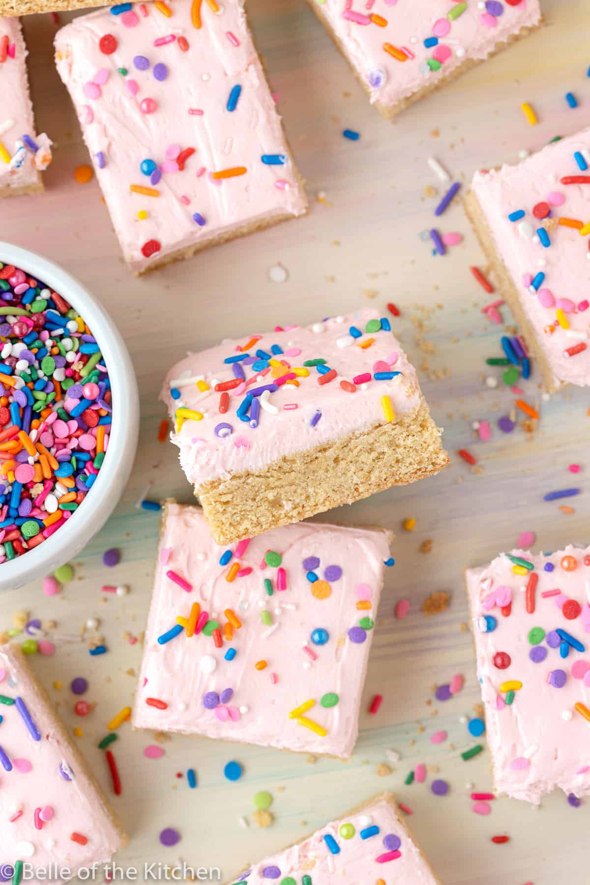 sugar cookie bars next to a bowl of sprinkles