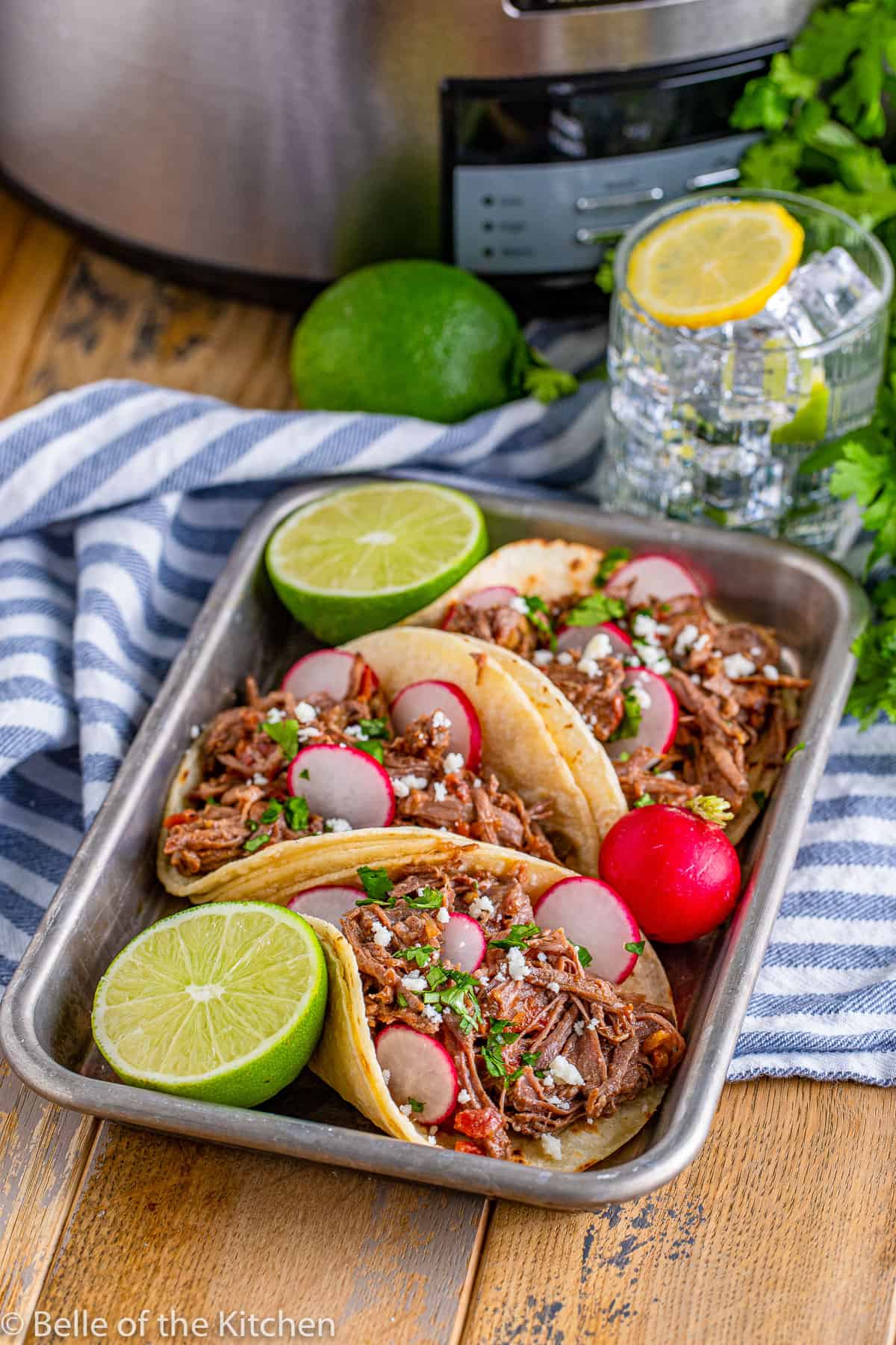 beef tacos on a tray with radishes