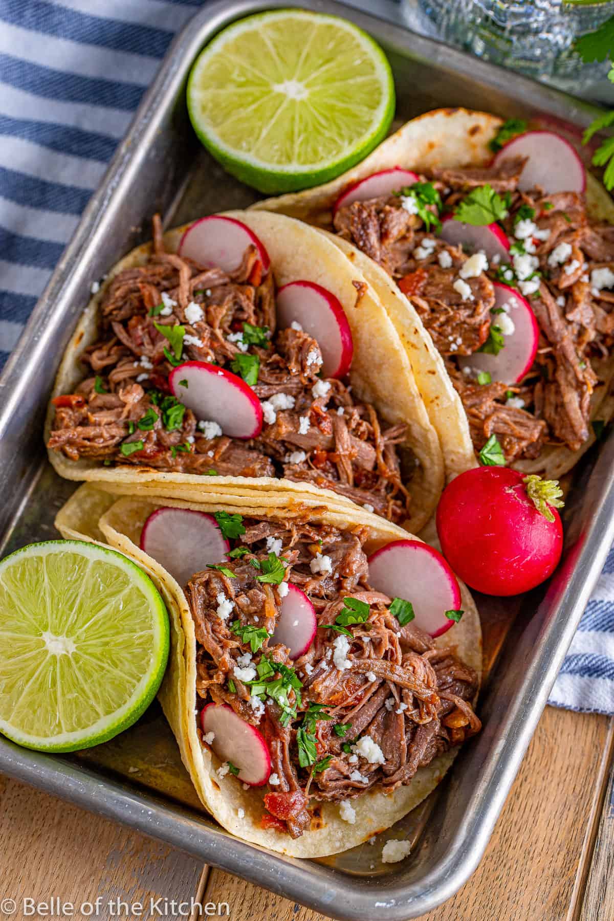 beef tacos on a tray with radishes