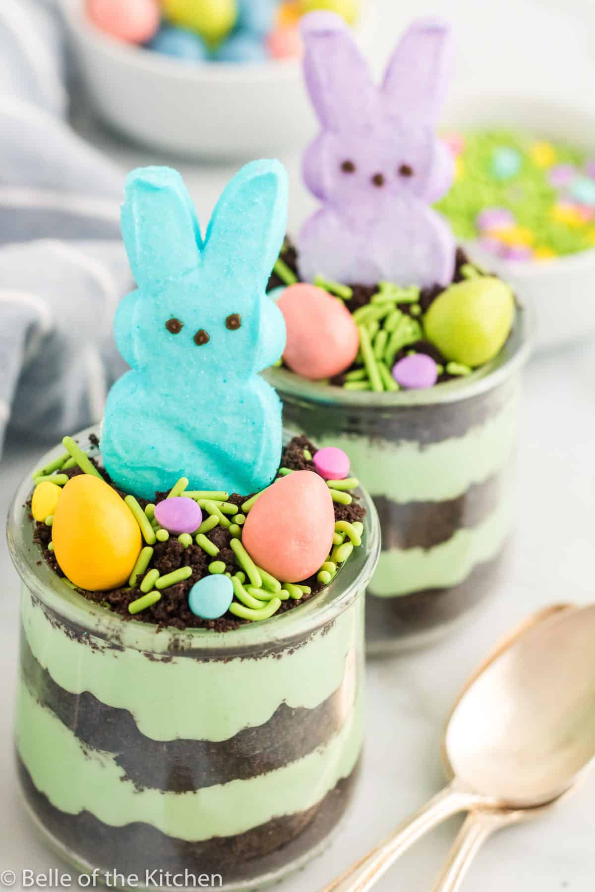 easter dirt cake cups next to spoons