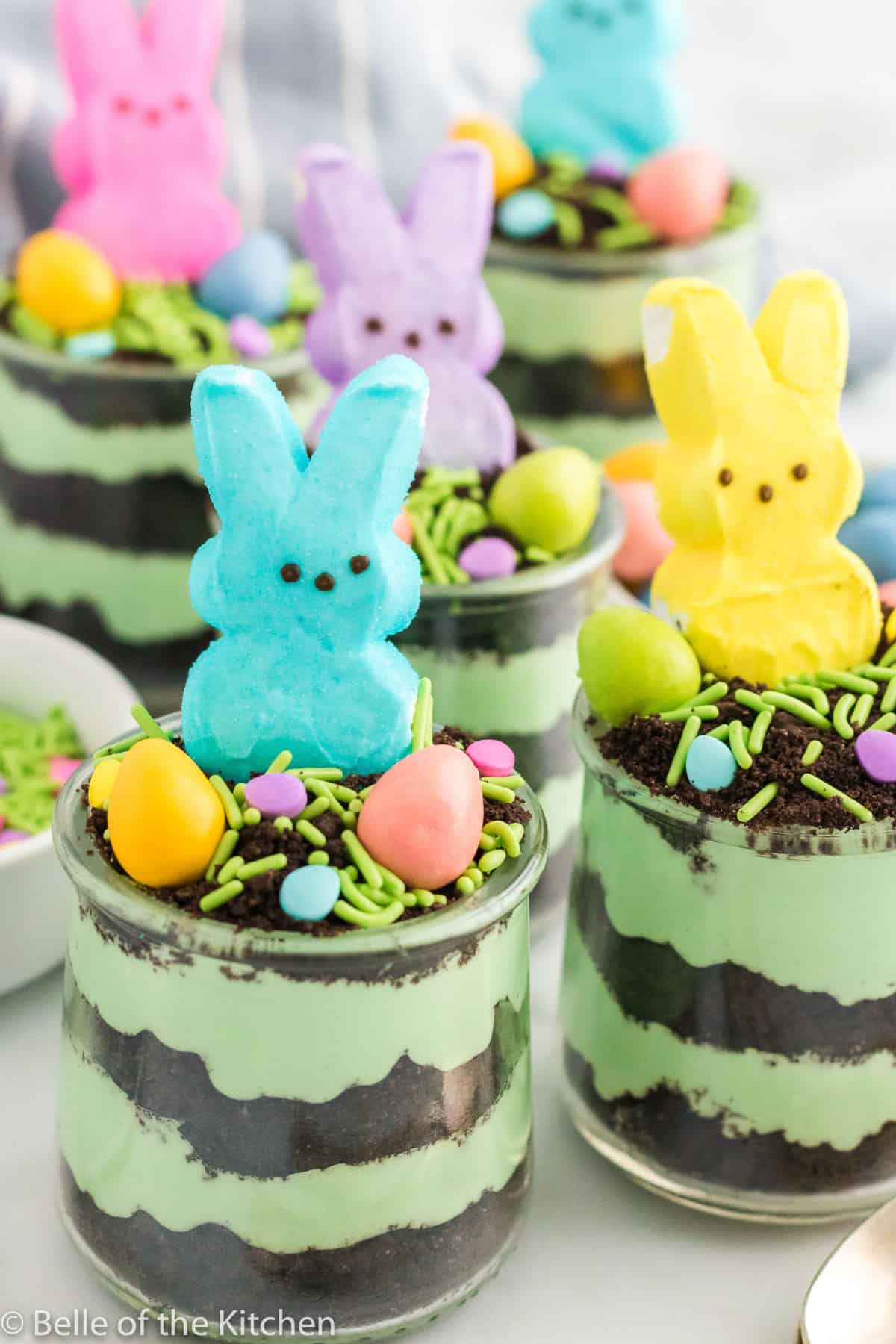 easter dirt cake cups next to spoons