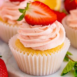 a strawberry lemon cupcake next to mint leaves