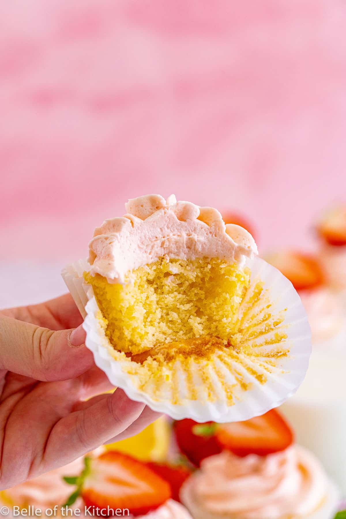 a lemon cupcake with a bite taken out