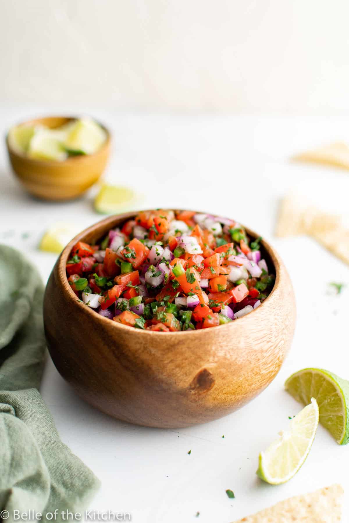 a wooden bowl holding fresh salsa