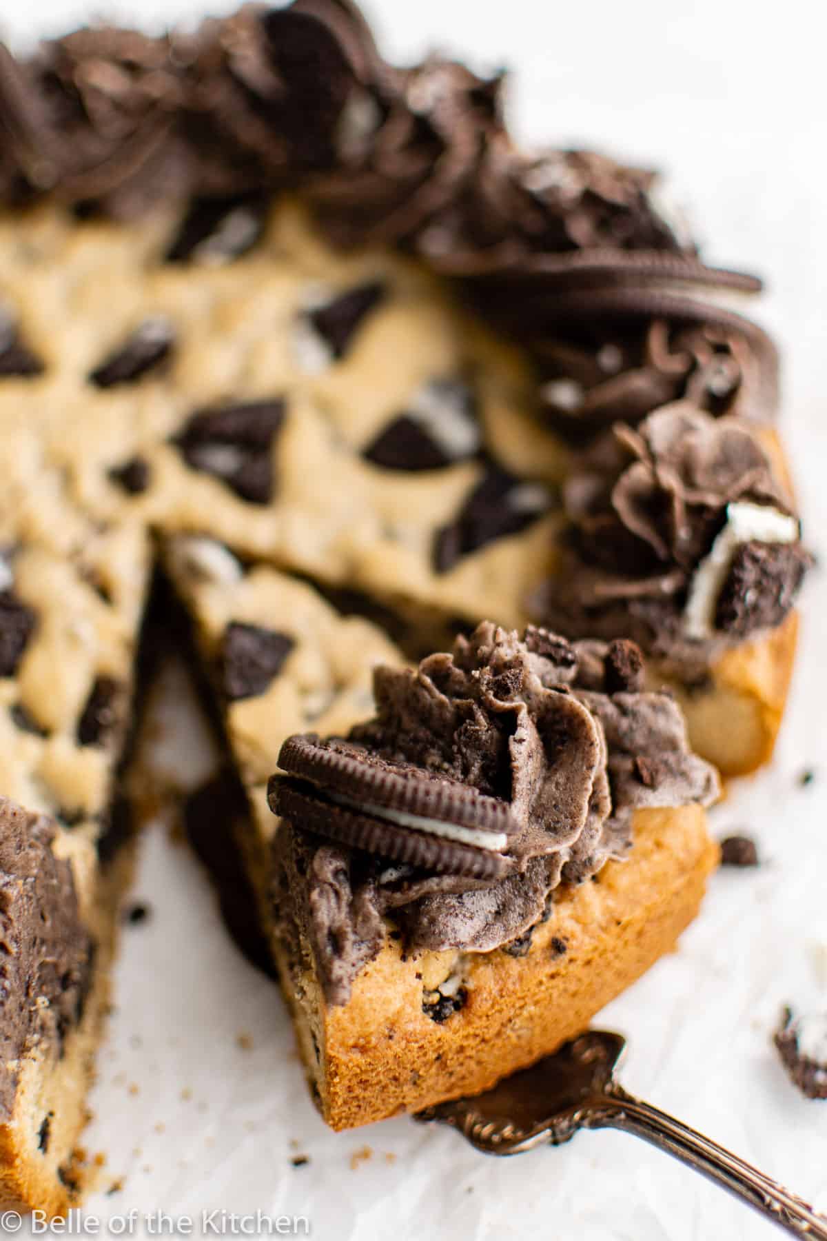 a slice of cookie cake with oreo frosting