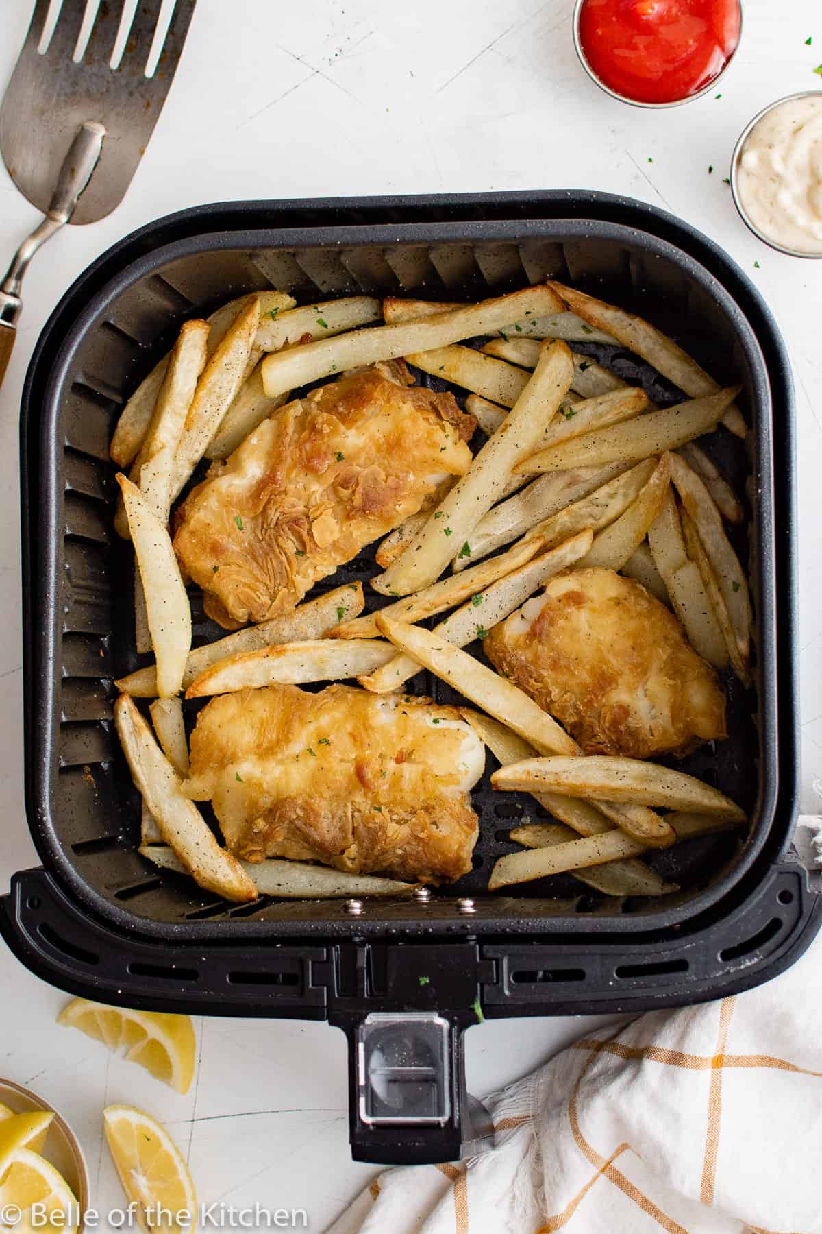 breaded fish and French fries in an air fryer basket