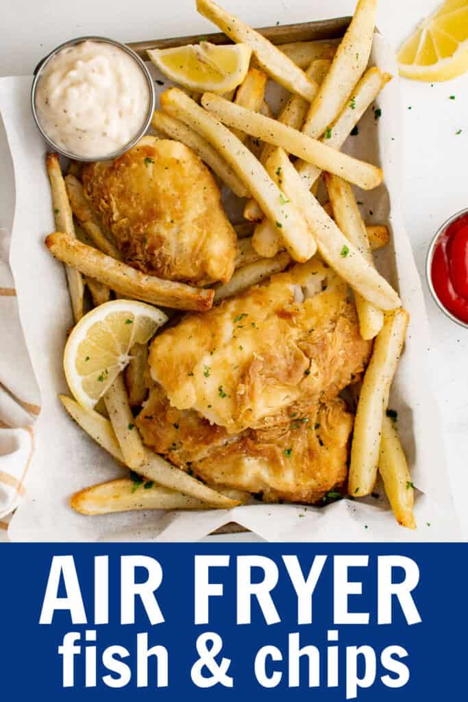 air fried fish on a tray with fries and lemon slices.