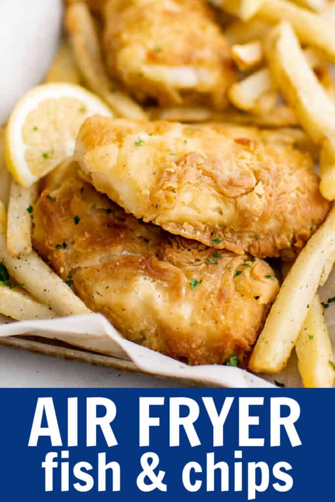 air fried fish on a tray with fries and lemon slices.