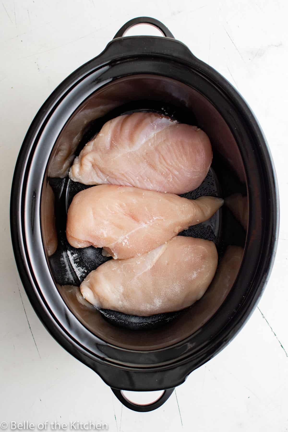 a crockpot full of chicken breasts.