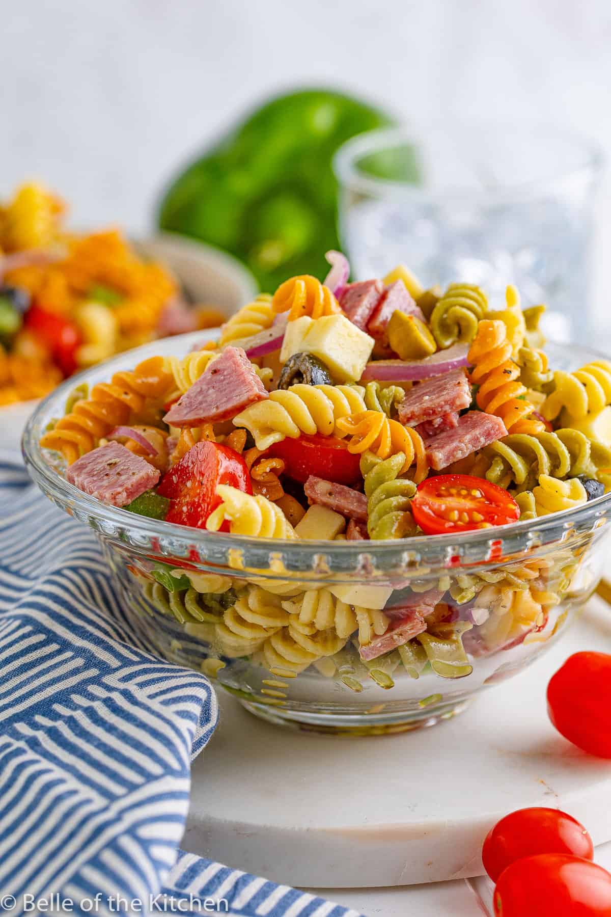 a glass bowl full of pasta salad