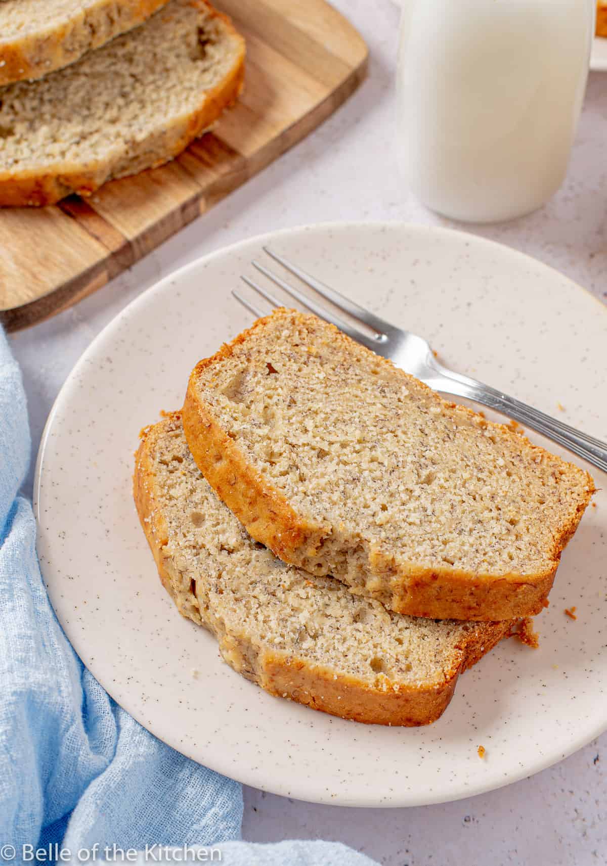 slices of banana bread on a plate next to a fork