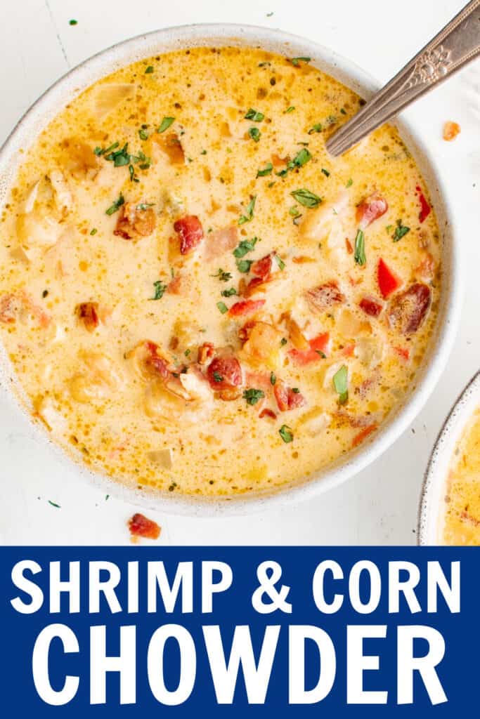 a bowl of shrimp and corn chowder with a spoon in it.