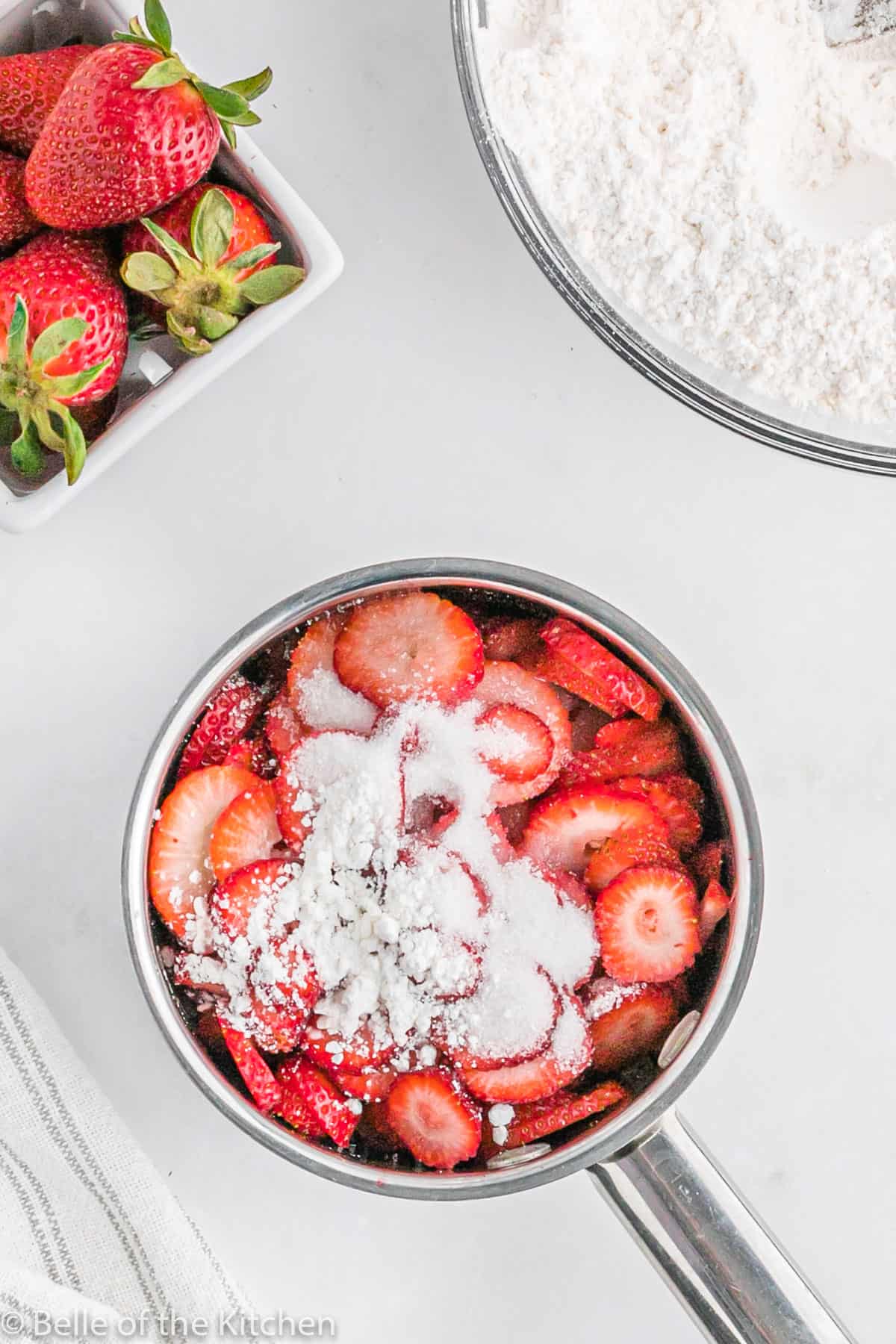 a sauce pan of strawberries and sugar