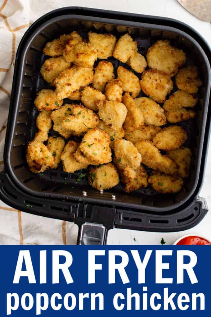an air fryer basket full of air fryer popcorn chicken pieces.