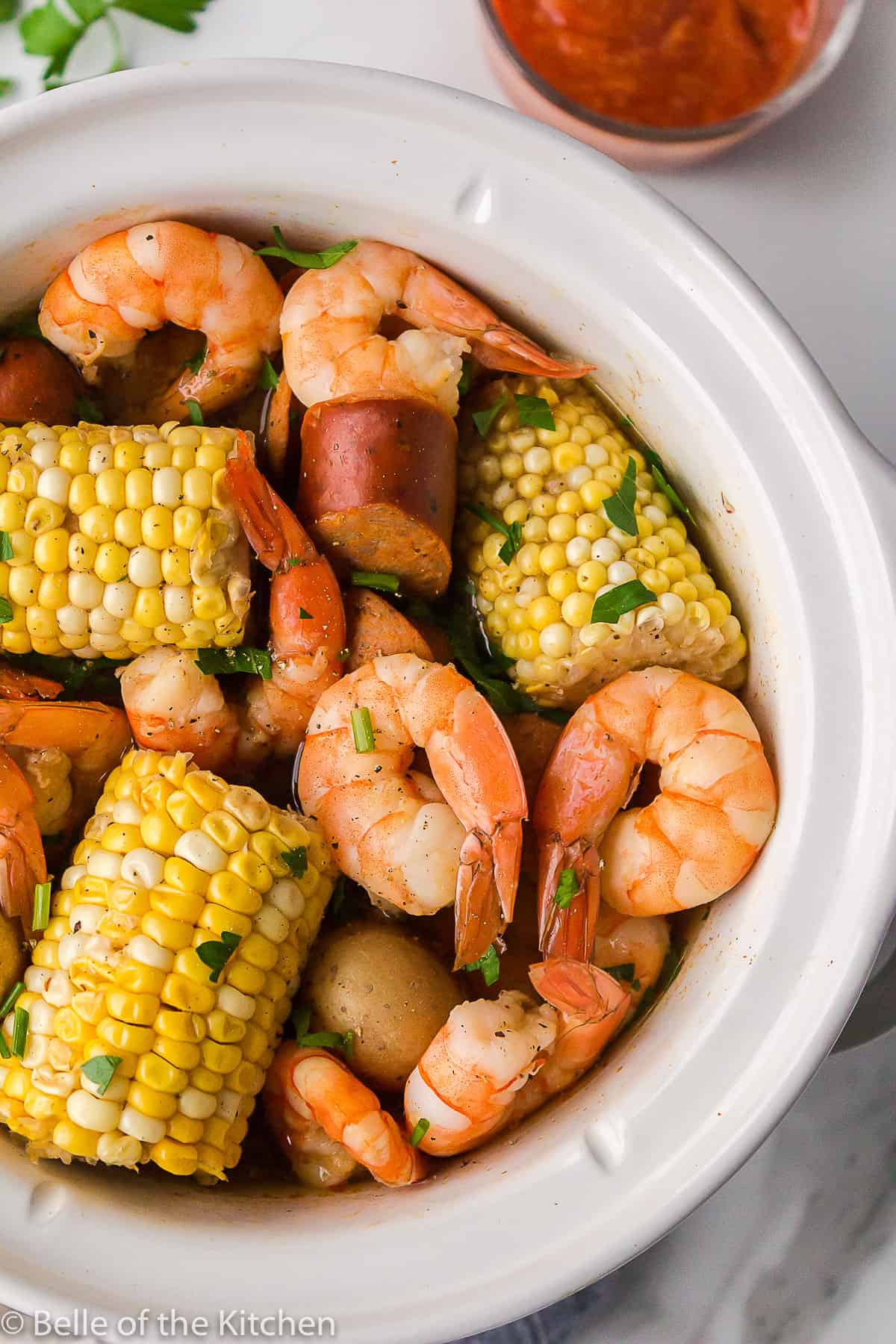 shrimp boil in a white crockpot.
