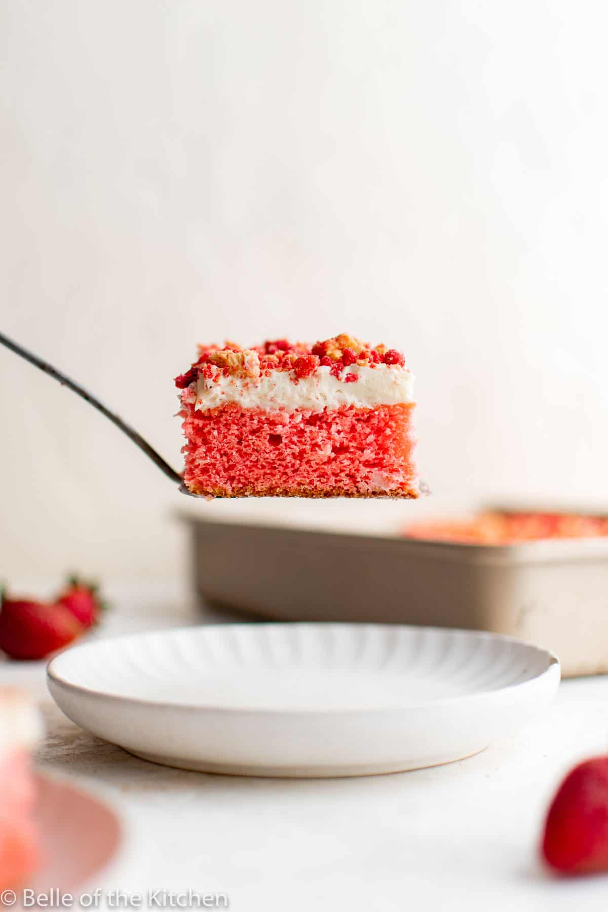 a spatula picking up a piece of cake from a pan.