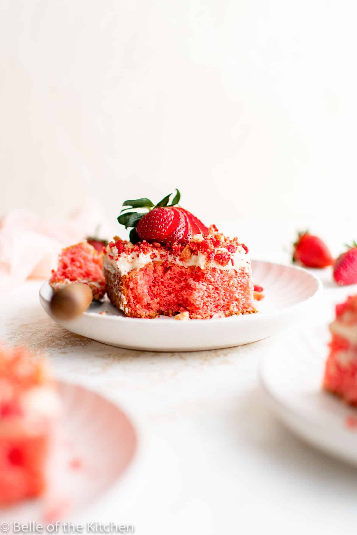 a slice of strawberry cake on a white plate.