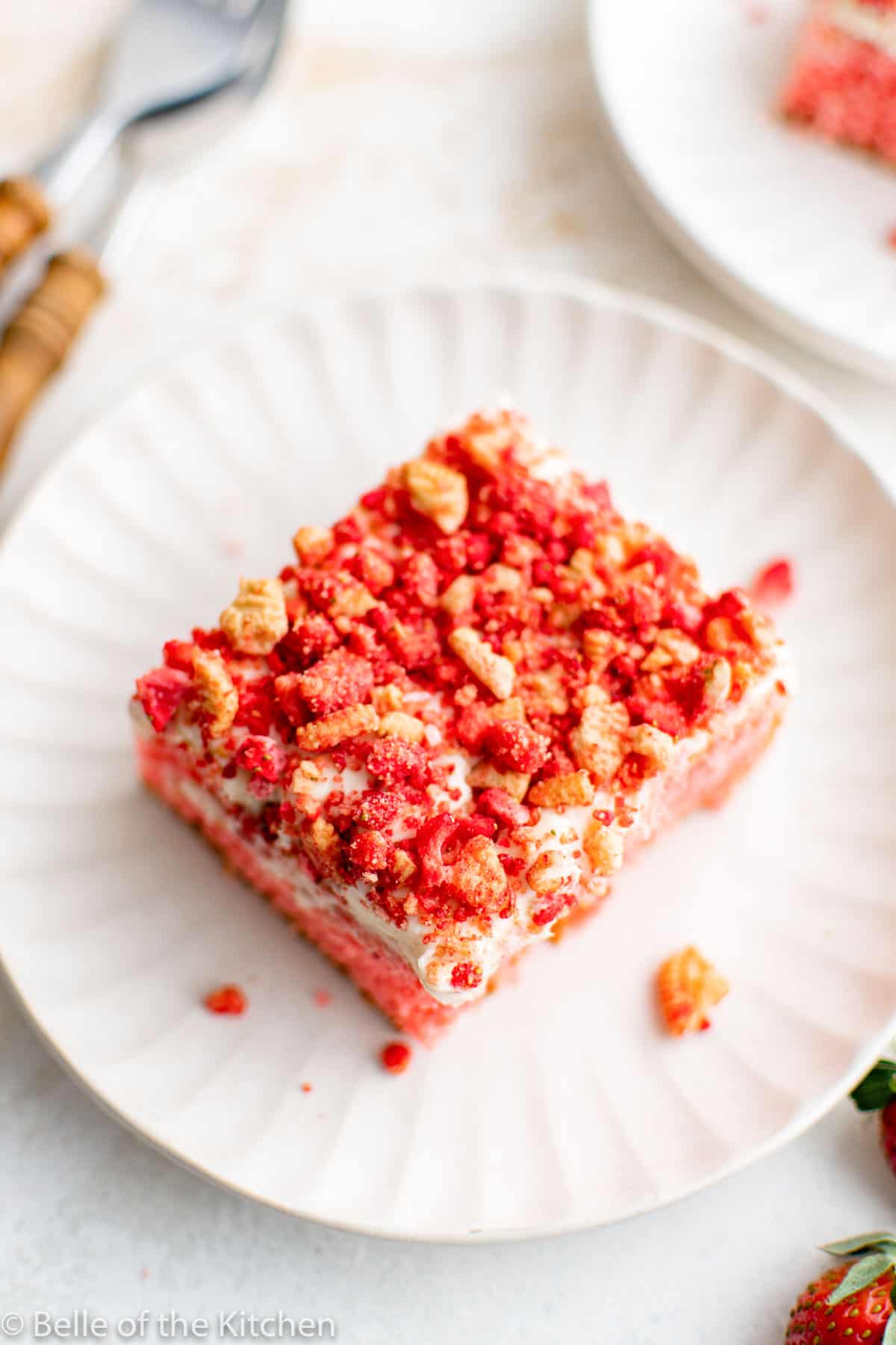 a slice of strawberry cake on a white plate.