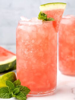 two glasses filled with ice, vodka, and watermelon.
