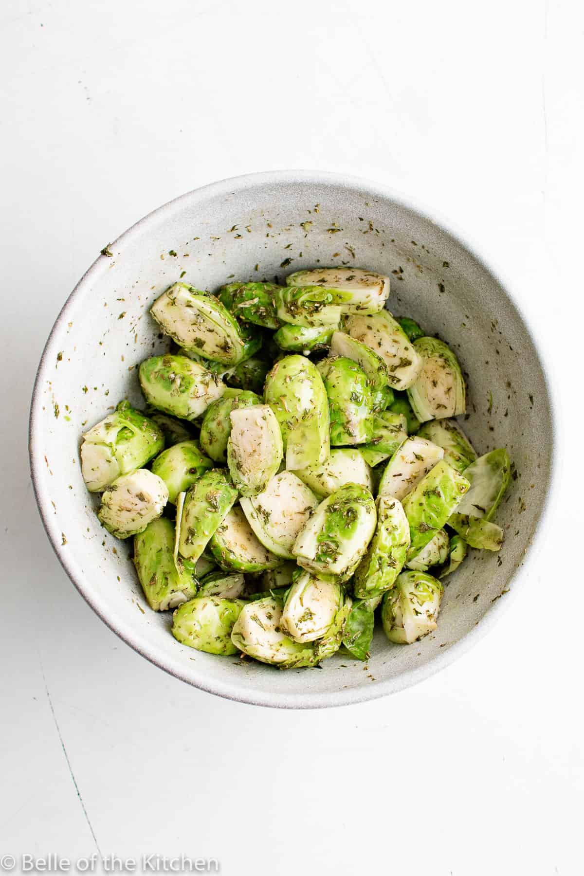 a white bowl of Brussels sprouts.