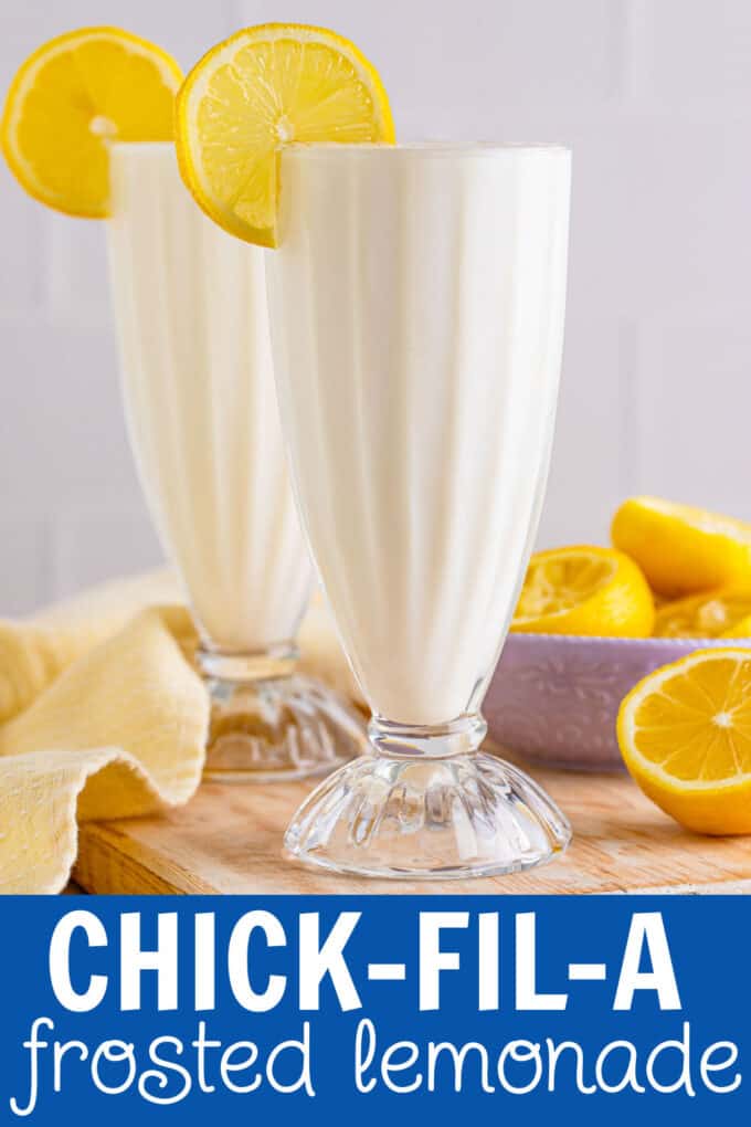 two glasses full of lemon milkshake with lemon slices on the side.