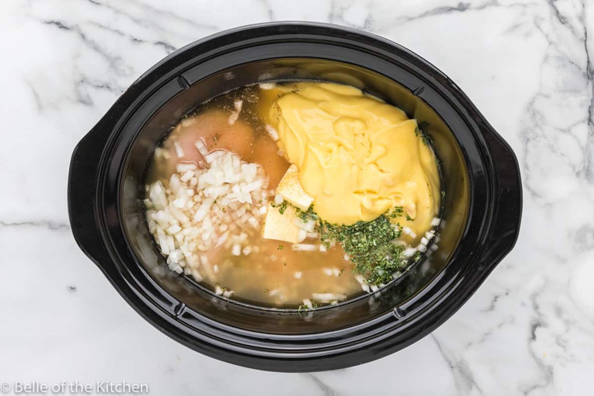 onions, soup, and chicken in a crockpot.