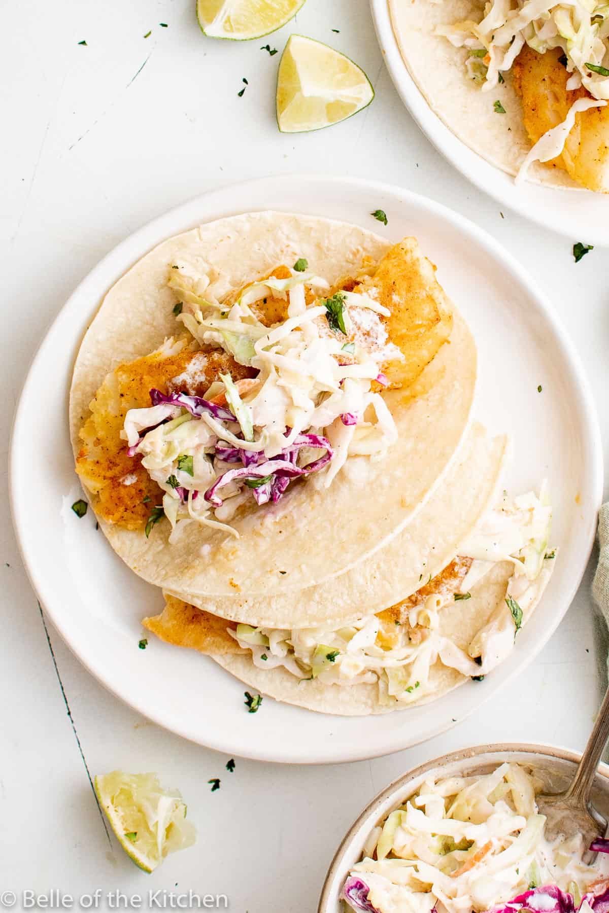 fish tacos on a white plate.
