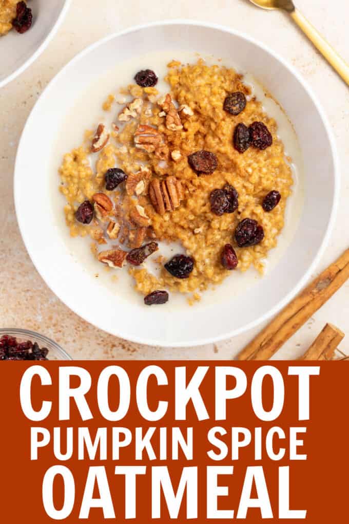 a bowl of pumpkin spice oatmeal topped with raisins and pecans.