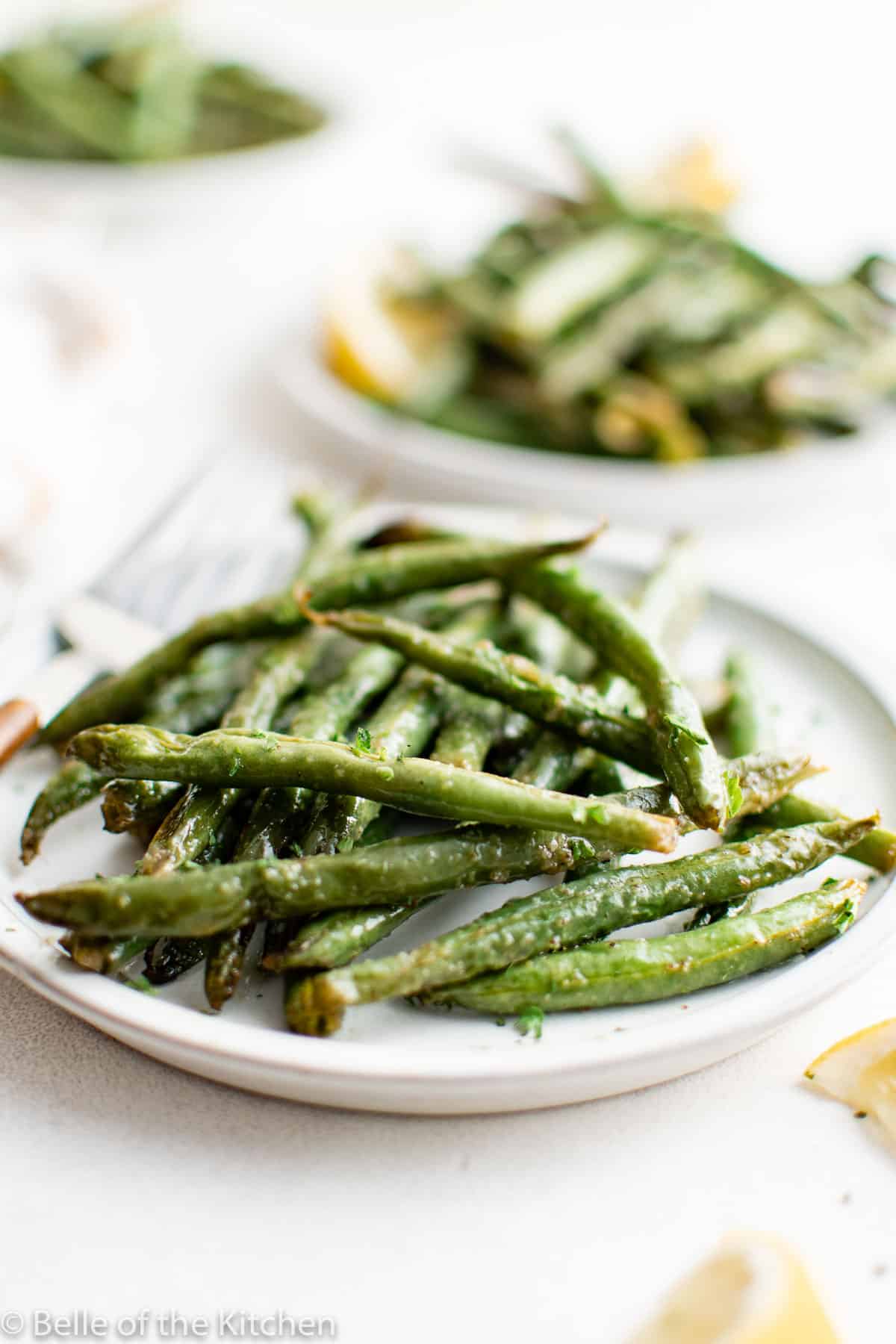 a plate full of cooked green beans.