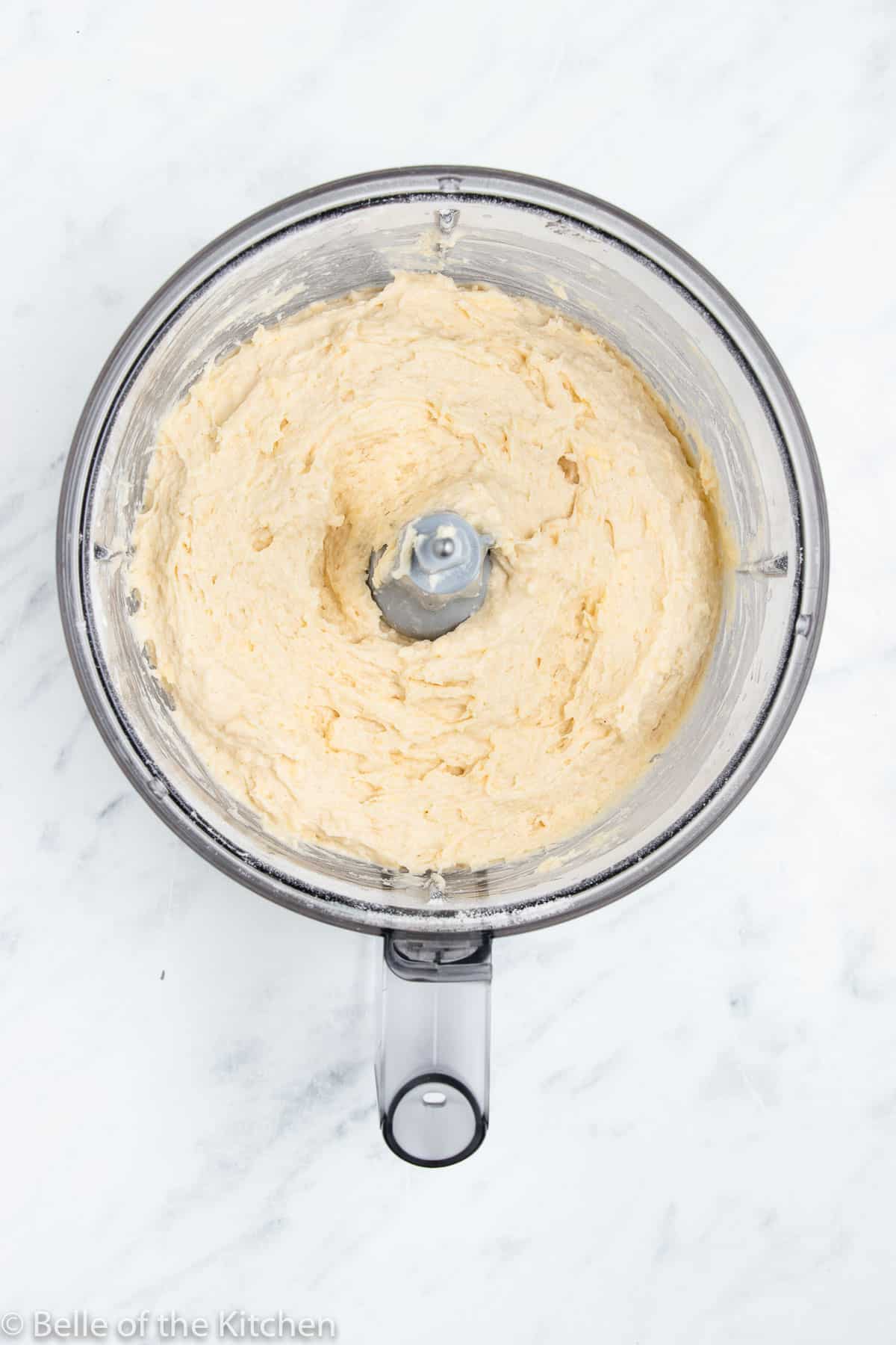 a food processor filled with dough.