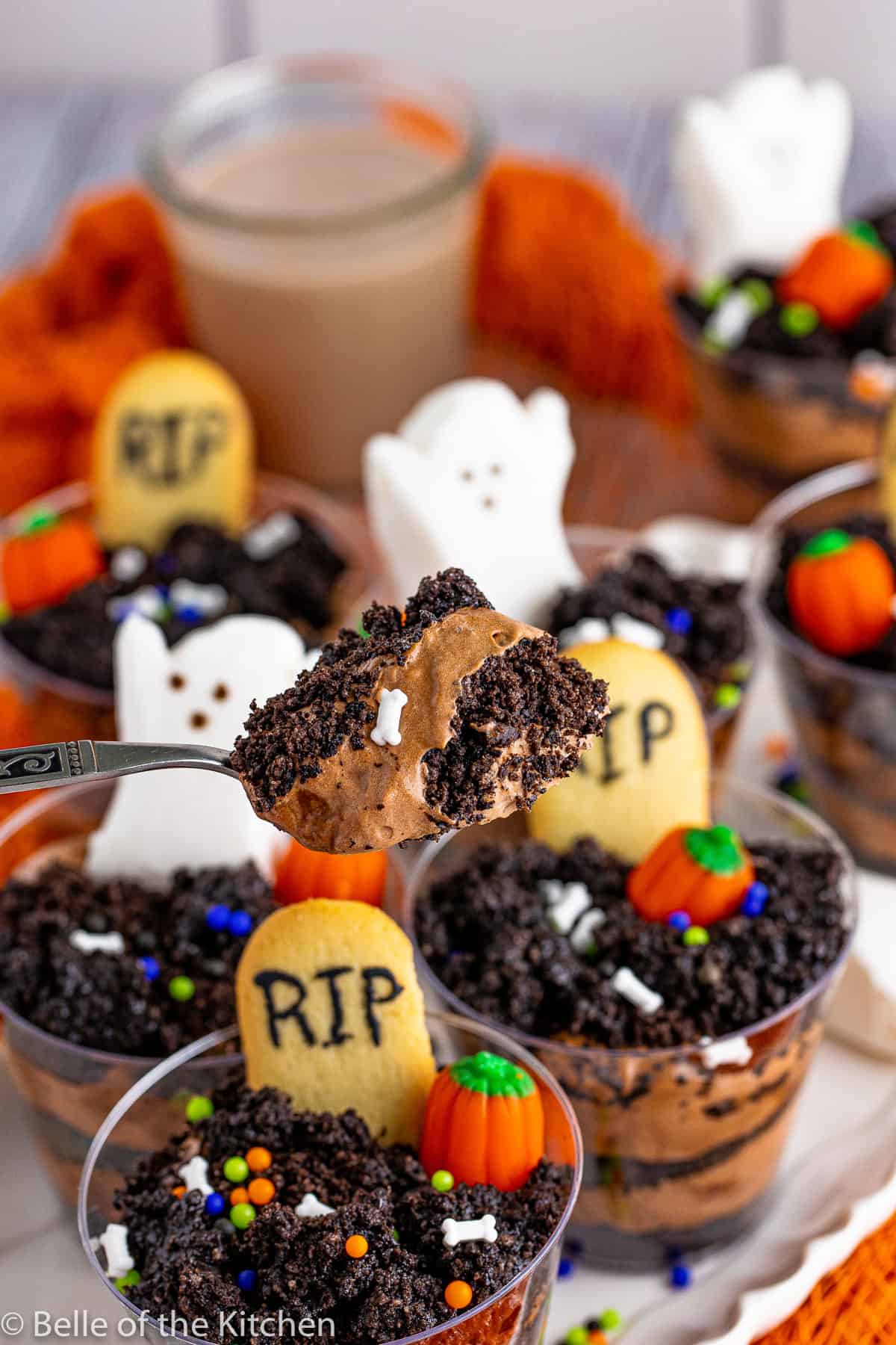 a spoon holding a scoop of pudding from halloween dirt cups.