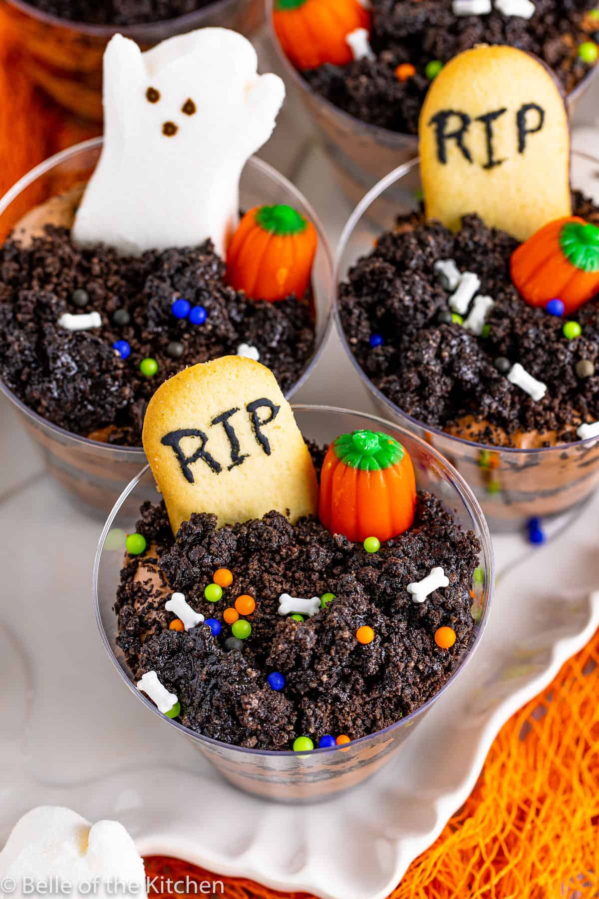 plastic cups full of crumbled Oreos, cookies, and candy pumpkins.