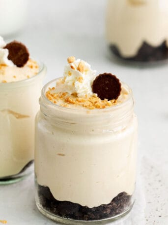 up close of a jar of peanut butter mousse with oreo crumbles on the bottom.