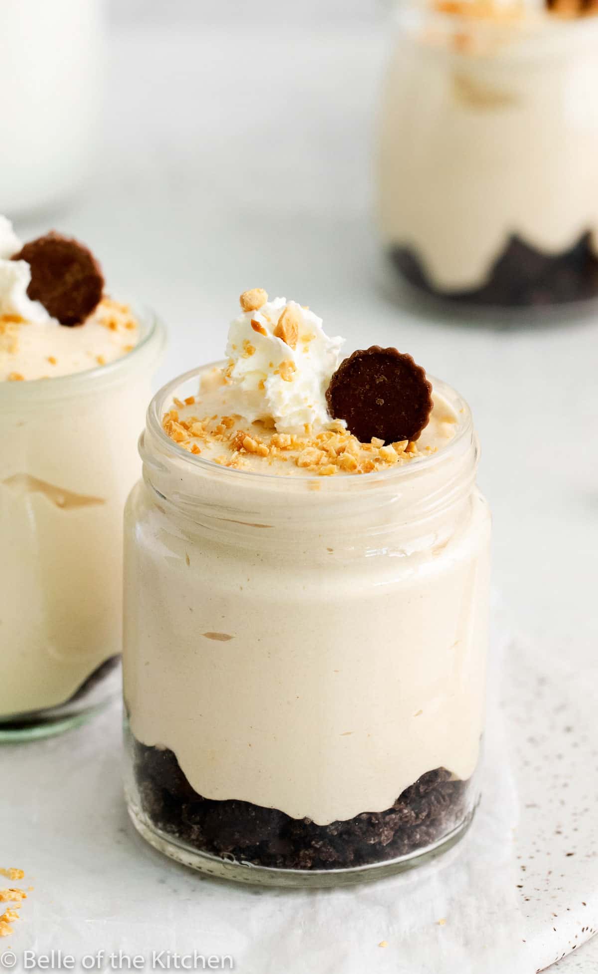 up close of a jar of peanut butter mousse with oreo crumbles on the bottom.