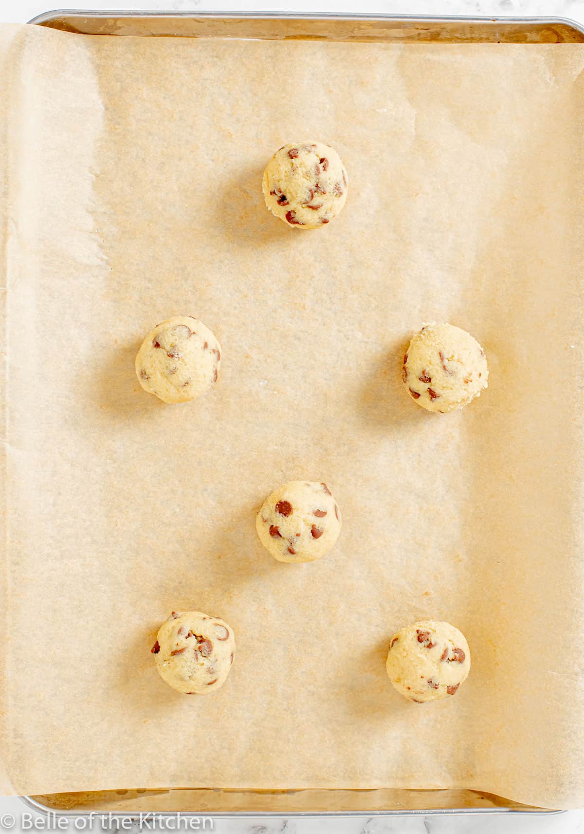 cookie dough balls on a sheet pan.