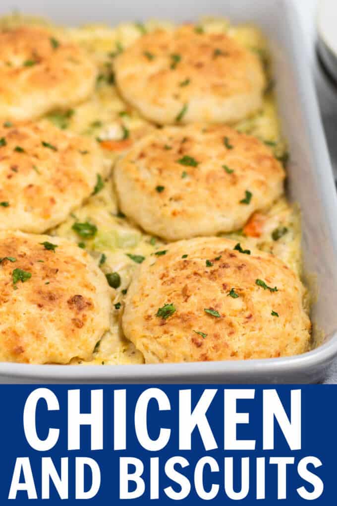 a baking dish full of chicken, vegetables, and biscuits.