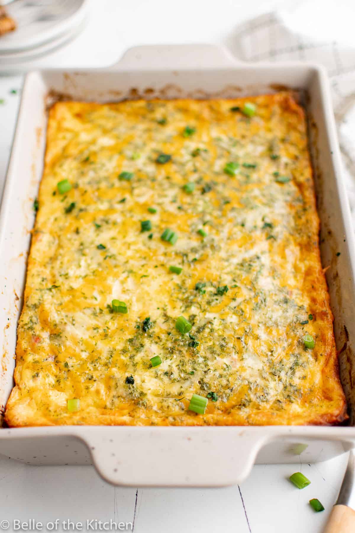a baking dish full of ham egg and cheese casserole.
